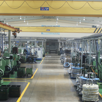 Company interior view with various green and gray machines