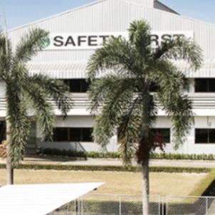Exterior view of the company with two palm trees and the word Safety written in white
