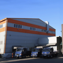 Company exterior image with orange stripe on white background