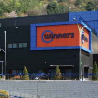 Company exterior background with the word WINNER written in English